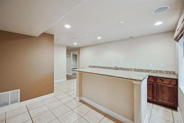 kitchen with light stone counters and light tile patterned floors