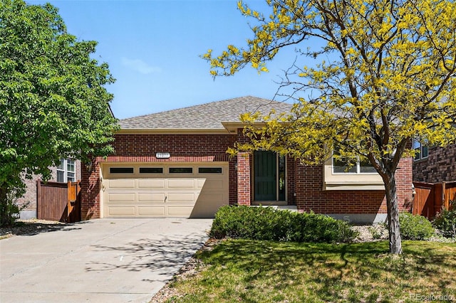 25077 E Canal Pl, Aurora, CO 80018 - view of front of house with brick siding, an attached garage, concrete driveway, and a shingled roof