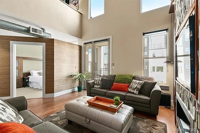 living room with a healthy amount of sunlight and hardwood / wood-style floors