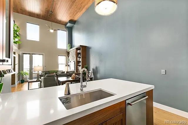 kitchen with french doors, sink, stainless steel dishwasher, wooden ceiling, and light hardwood / wood-style flooring