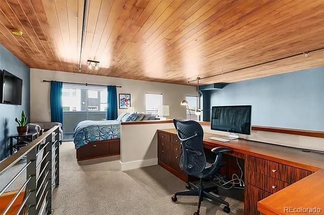 carpeted bedroom with wood ceiling