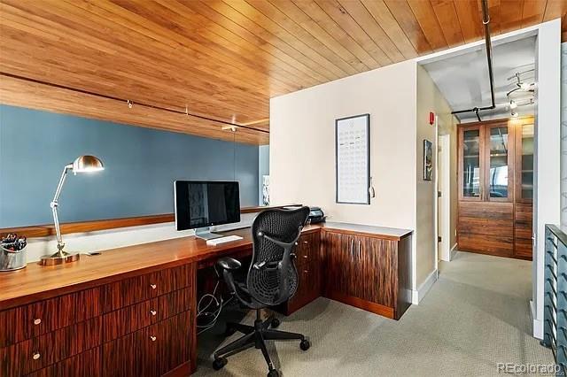 office featuring light carpet and wooden ceiling