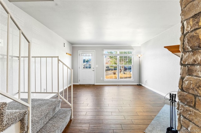 foyer with dark wood finished floors, stairway, and baseboards