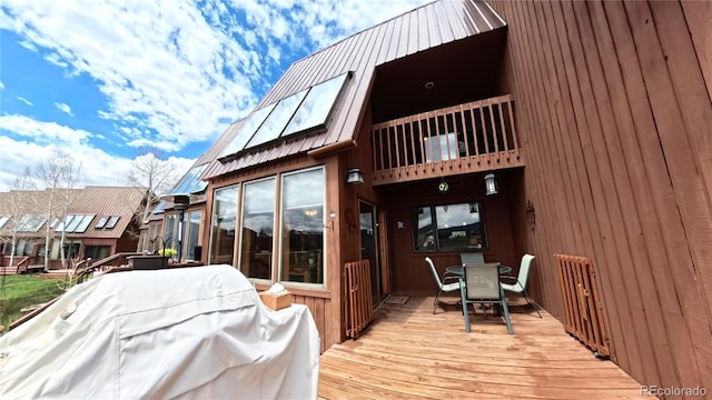 366 Gcr 4421, Grand Lake, CO 80557 - rear view of house with a balcony, outdoor dining area, metal roof, and a standing seam roof