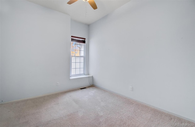 carpeted empty room featuring ceiling fan