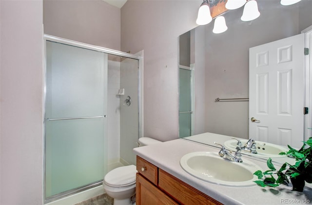 bathroom with vanity, toilet, and walk in shower