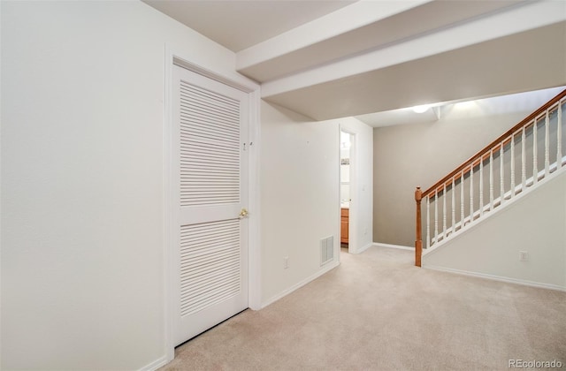 interior space featuring light carpet