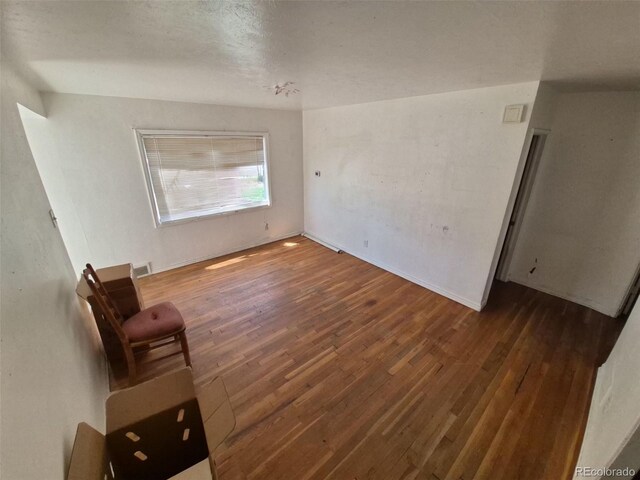 1266 Del Mar Pkwy, Aurora, CO 80010 - spare room with wood-type flooring and baseboards