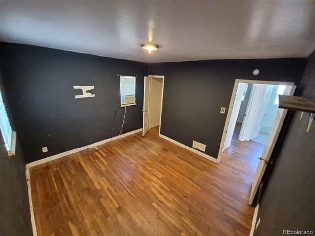 1266 Del Mar Pkwy, Aurora, CO 80010 - spare room featuring wood finished floors and baseboards