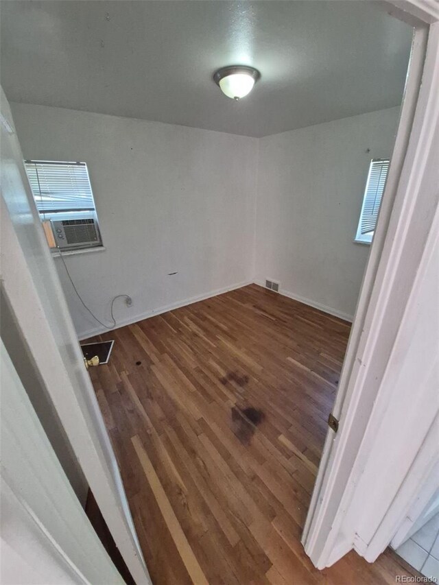 1266 Del Mar Pkwy, Aurora, CO 80010 - empty room with wood finished floors and cooling unit