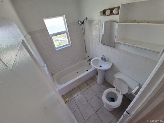 1266 Del Mar Pkwy, Aurora, CO 80010 - bathroom featuring toilet, tile patterned flooring, tile walls, and shower / bath combination