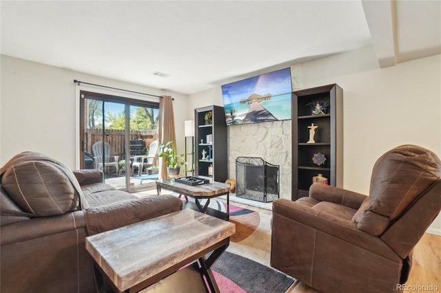 living area featuring a stone fireplace