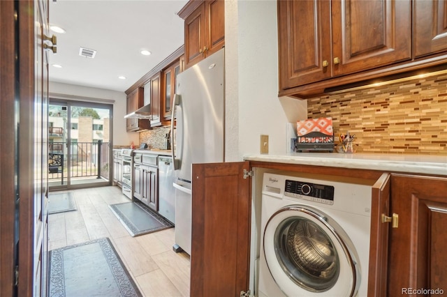 laundry room featuring washer / dryer, light wood-style floors, and recessed lighting
