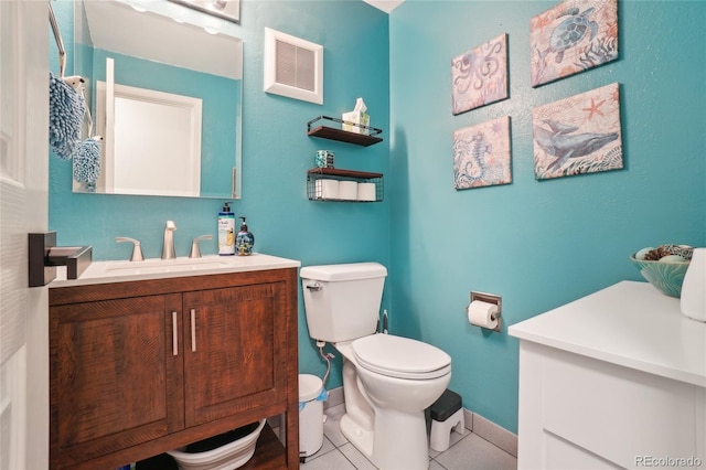 bathroom with tile patterned flooring, toilet, vanity, and baseboards
