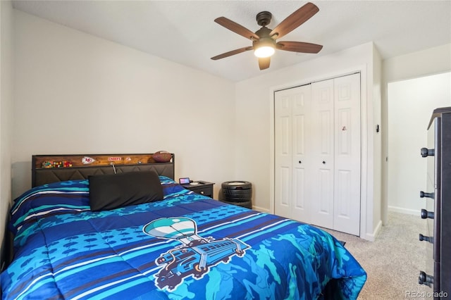 carpeted bedroom featuring a closet, baseboards, and a ceiling fan