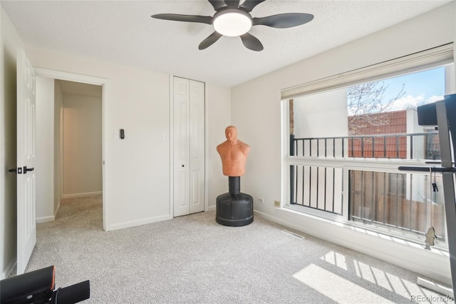 unfurnished room featuring a ceiling fan, carpet flooring, and baseboards
