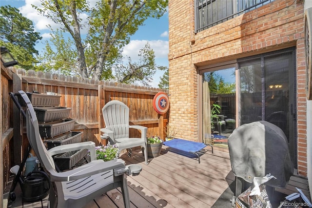 wooden terrace featuring a fenced backyard