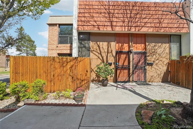 view of outbuilding with fence and a gate
