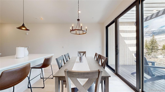 dining room with light wood-style flooring and a chandelier