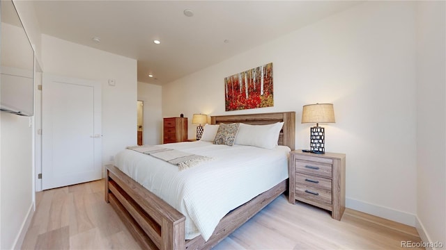 bedroom with light wood-style floors, baseboards, and recessed lighting