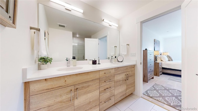 full bath with double vanity, visible vents, connected bathroom, tile patterned flooring, and a sink