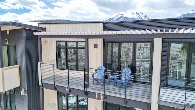 exterior space featuring a mountain view and a balcony