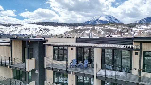 snow covered property with a mountain view