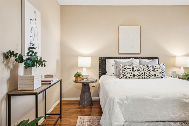 bedroom with wood finished floors and baseboards