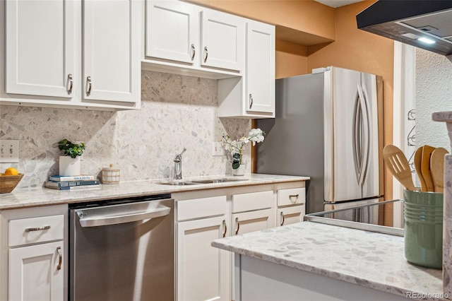 kitchen with tasteful backsplash, appliances with stainless steel finishes, extractor fan, and a sink