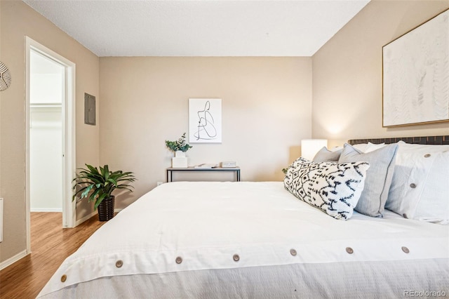 bedroom with wood finished floors and baseboards