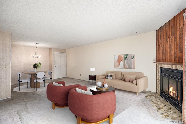 living room with a textured ceiling, light colored carpet, and a chandelier