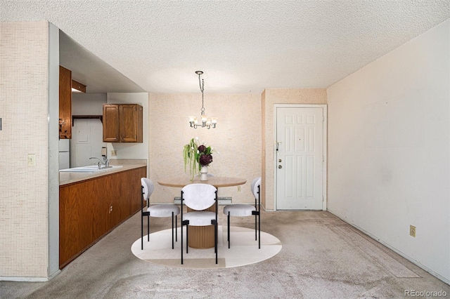 carpeted dining space with sink, a textured ceiling, and a notable chandelier