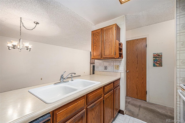 kitchen with pendant lighting, sink, decorative backsplash, a textured ceiling, and an inviting chandelier