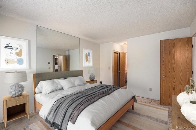 carpeted bedroom with a textured ceiling