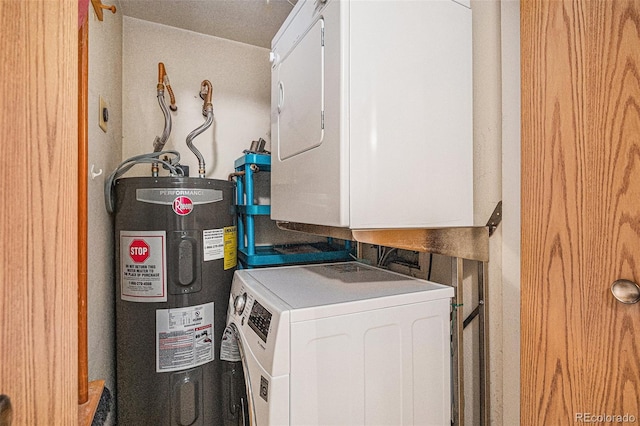 utility room featuring stacked washer / dryer and electric water heater