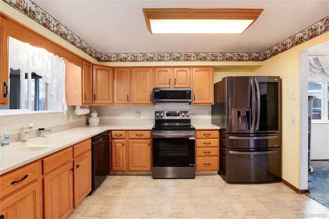 kitchen featuring backsplash, a wealth of natural light, and stainless steel appliances