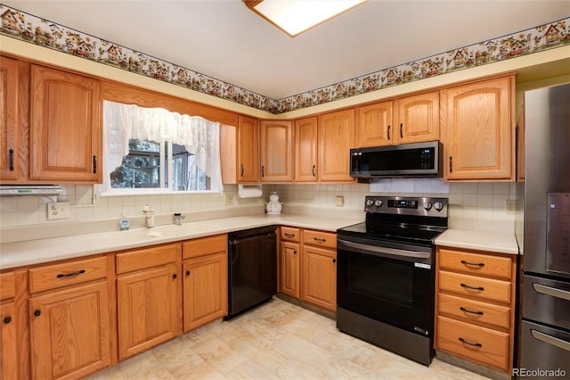 kitchen with tasteful backsplash, sink, and stainless steel appliances