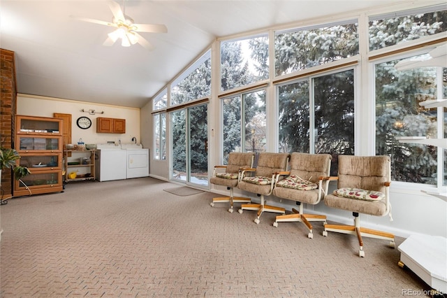 sunroom / solarium featuring ceiling fan, washing machine and clothes dryer, and lofted ceiling