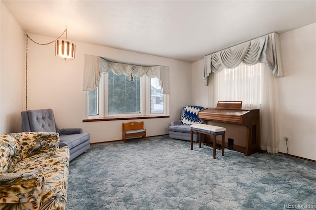 living area featuring a healthy amount of sunlight and carpet