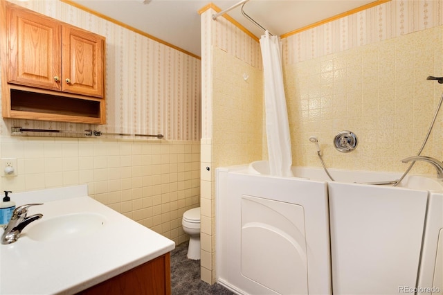 full bathroom with shower / tub combo, tile walls, vanity, ornamental molding, and toilet