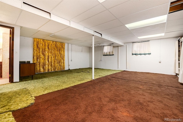 basement with carpet floors and a drop ceiling