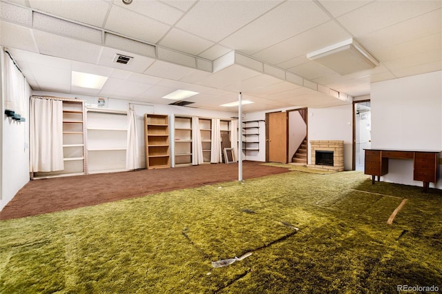 basement with carpet flooring and a drop ceiling