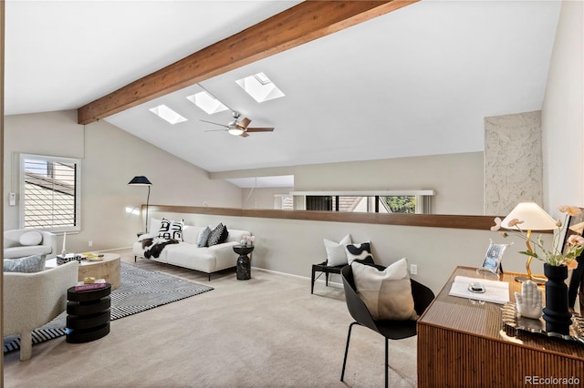 home office with ceiling fan, light carpet, lofted ceiling with skylight, and a wealth of natural light