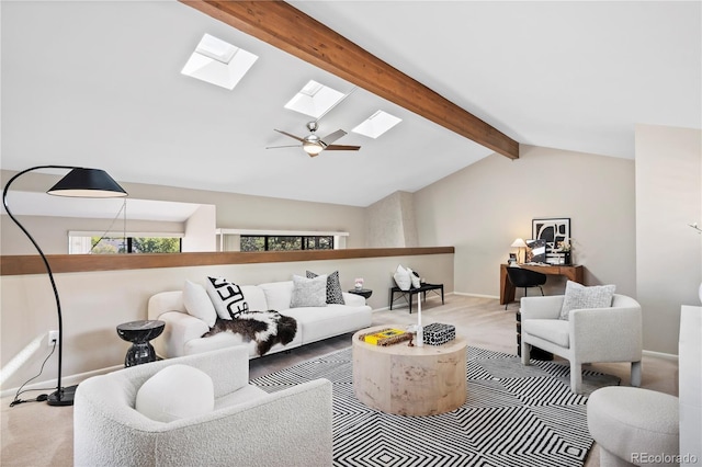 living room featuring lofted ceiling with skylight, light carpet, and ceiling fan