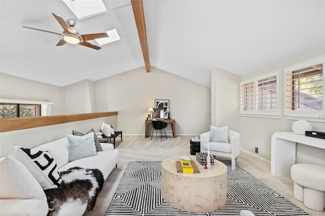 living room featuring carpet flooring, lofted ceiling with skylight, and ceiling fan