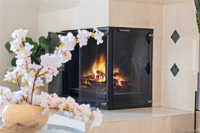 interior details featuring a tile fireplace