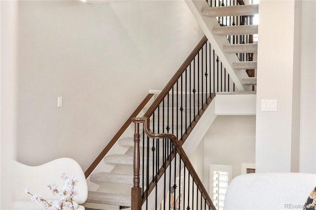 stairs featuring a towering ceiling