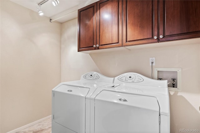 laundry area with cabinets, track lighting, and independent washer and dryer