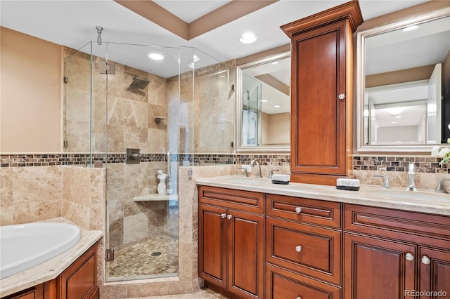 bathroom with tile walls, vanity, and separate shower and tub