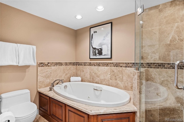 bathroom with shower with separate bathtub, tile walls, and toilet